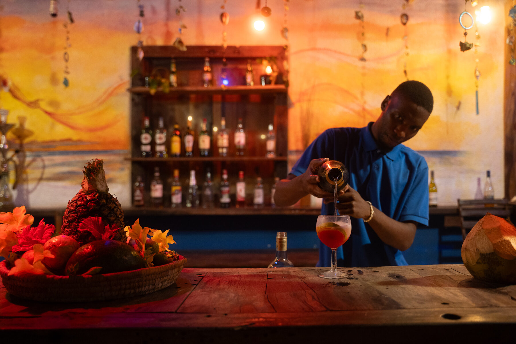 A member of the bar team preparing a drink